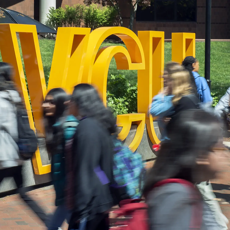 Students walking past VCU sculpture